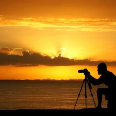 Photographer capturing a sunset while at the beach